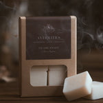 Antiquities wax melt cubes in kraft packaging with a dark brown label