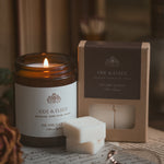 Ode & Elegy candle and wax melt on old letters with a blurred background