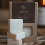 Sanctum wax melt cubes in kraft packaging with dark brown label