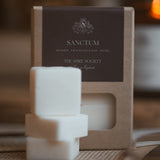 Sanctum wax melt cubes in kraft packaging with dark brown label