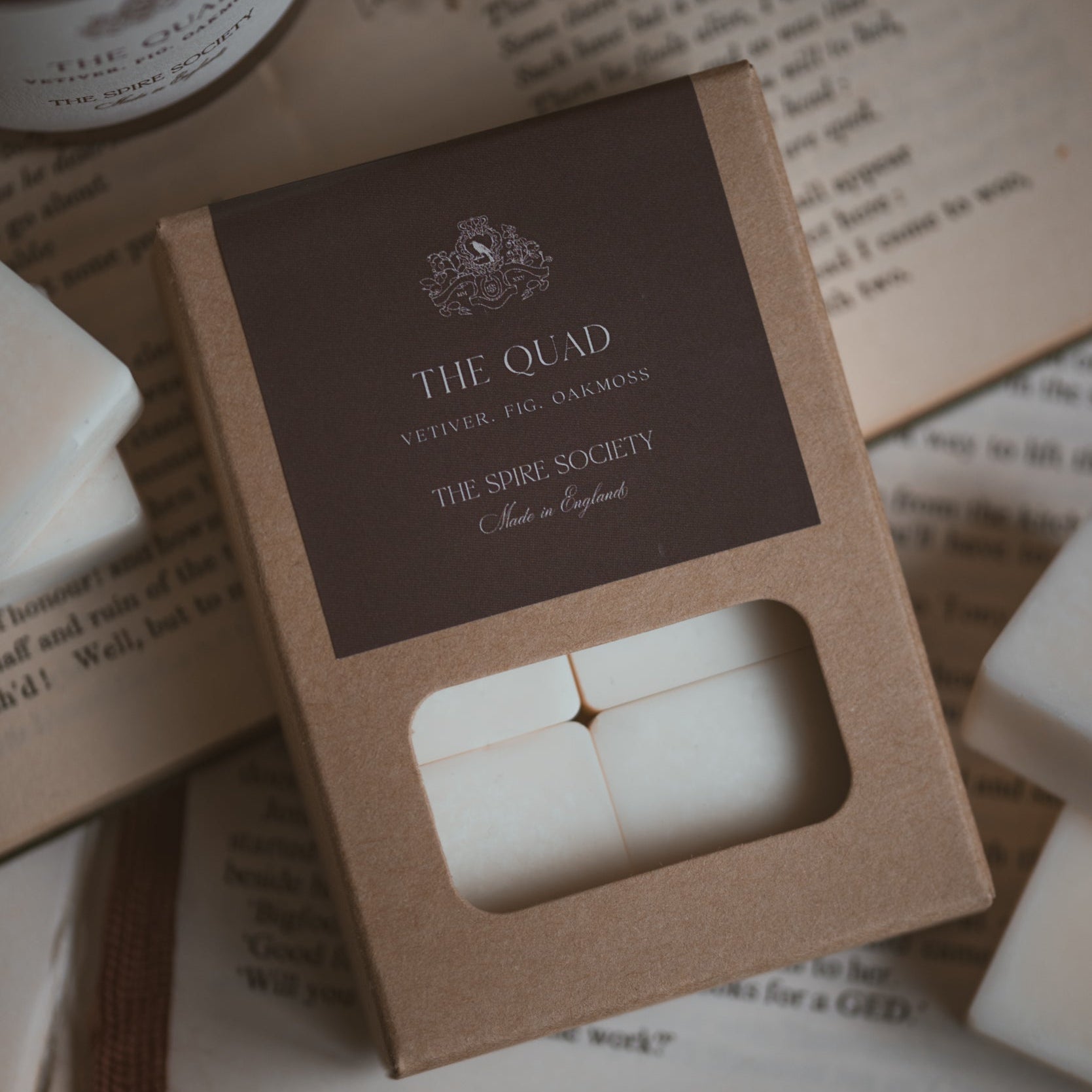 The Quad wax melt cubes in kraft packaging with a dark brown label